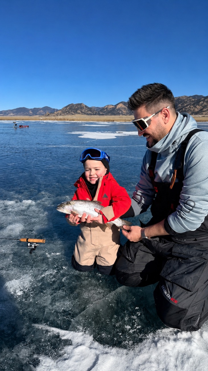 My son grinning with a rainbow trout he caught through the ice at Eleven Mile Reservoir