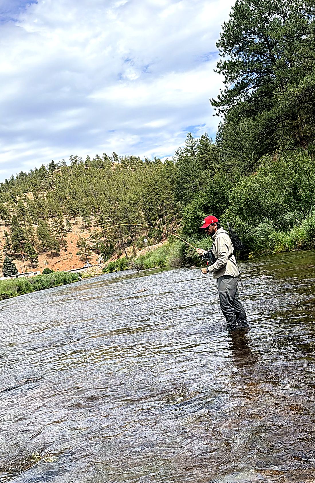 The full arc — the Gallatin bent right through the middle on a cast, big Colorado sky behind it