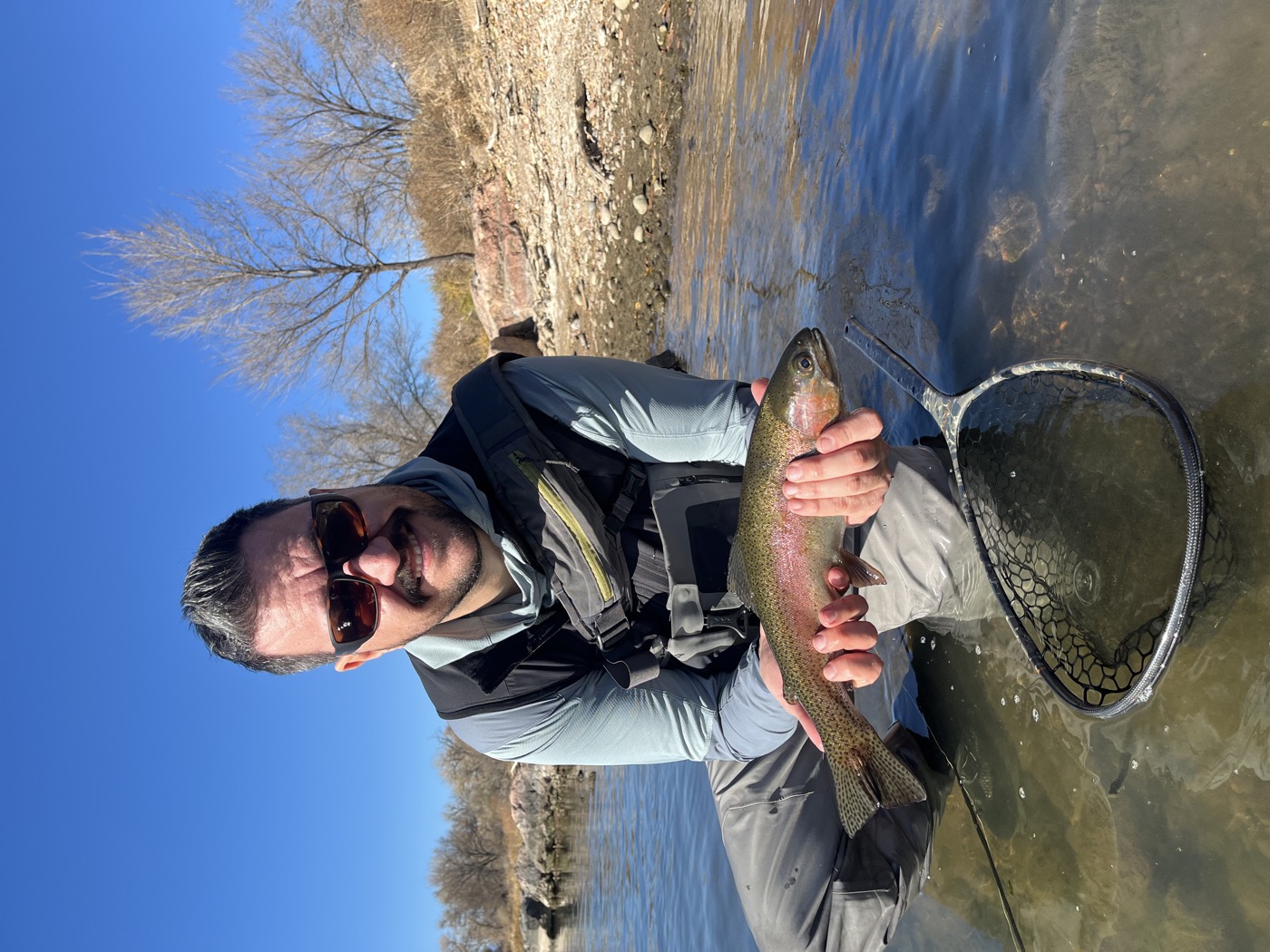 A rainbow held over clear South Platte current before release — read the seam right and this is where the drift ends